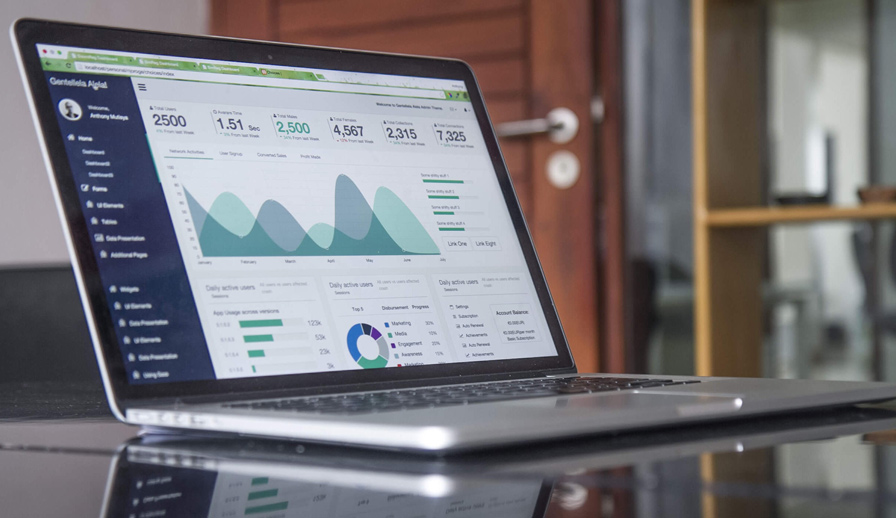 Laptop open with charts.